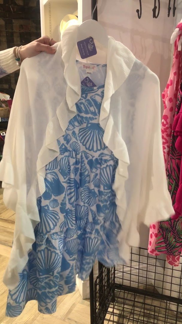 Women’s clothing and gift items arranged on display tables.