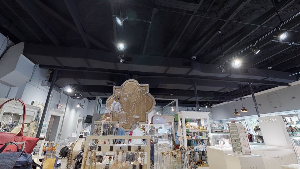 Women’s clothing and gift items arranged on display tables.